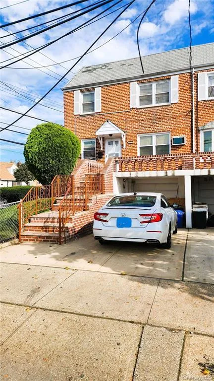 Traditional home featuring concrete driveway, brick siding, and roof with shingles Traditional home featuring concrete driveway, brick siding, and roof with shingles