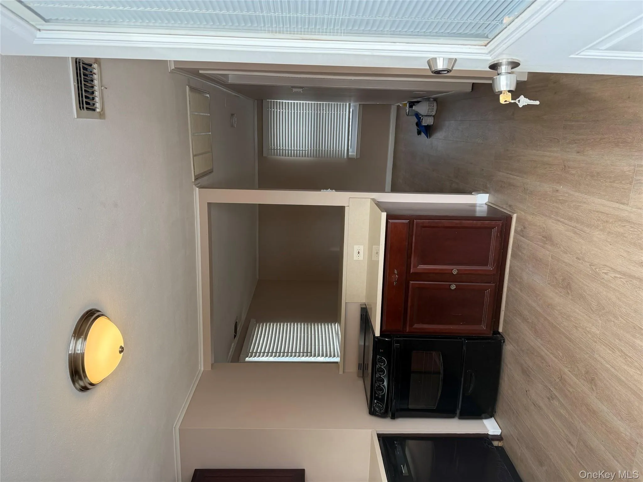 Kitchen with stove, dishwashing machine, light countertops, and light wood-style floors Kitchen with stove, dishwashing machine, light countertops, and light wood-style floors