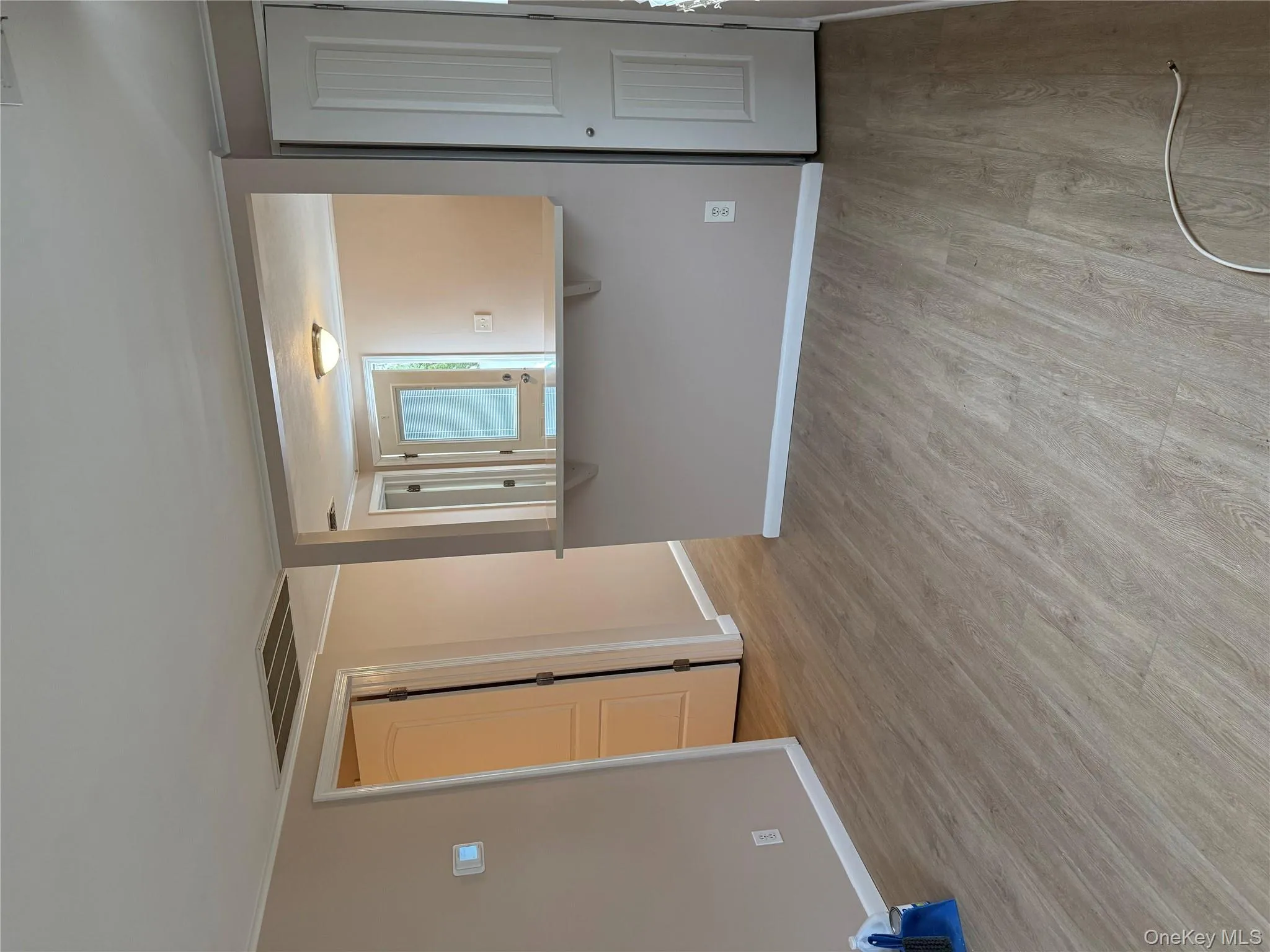 Unfurnished living room featuring light wood-style floors also with closet Unfurnished living room featuring light wood-style floors also with closet