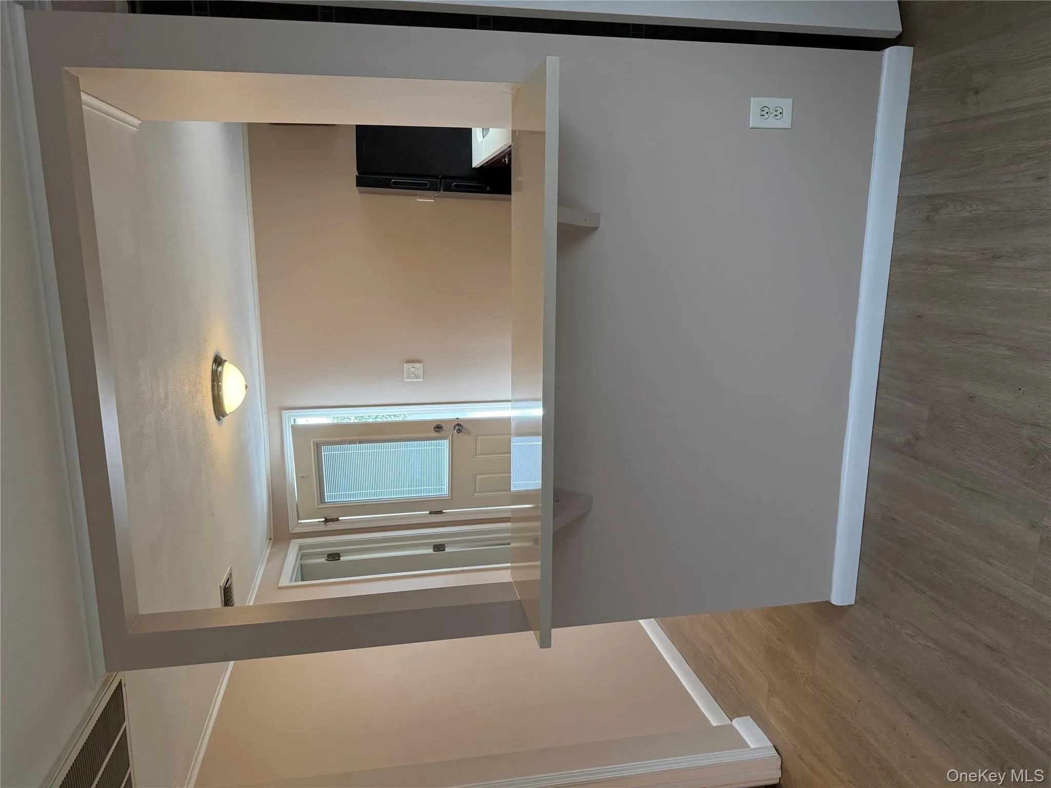 Kitchen with a kitchen breakfast bar, ornamental molding, fridge, light wood finished floors, and light countertops Kitchen with a kitchen breakfast bar, ornamental molding, fridge, light wood finished floors, and light countertops