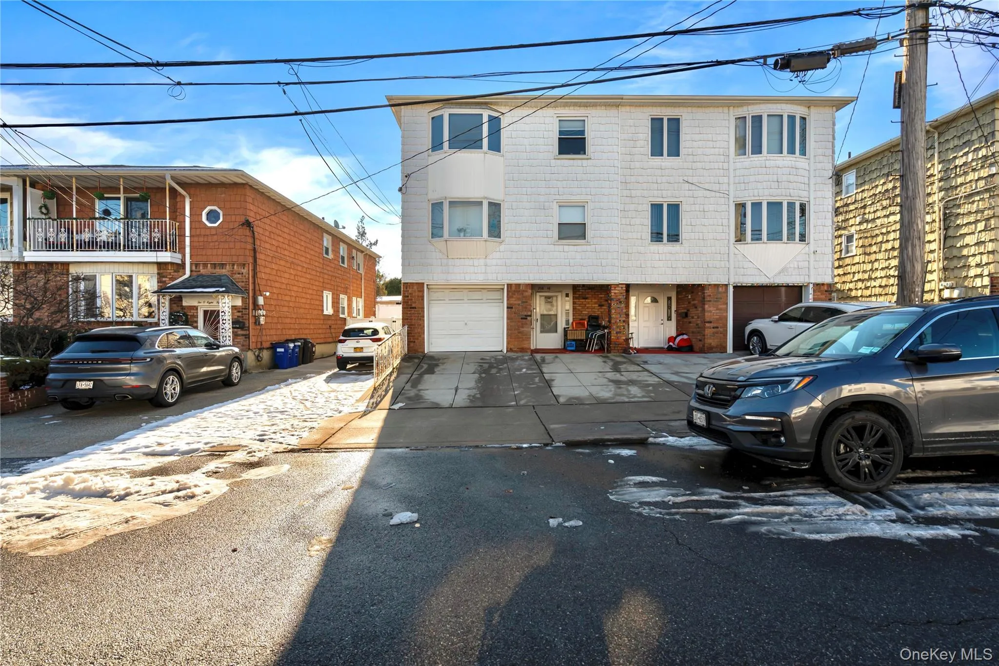 View of front facade with asphalt driveway and brick siding View of front facade with asphalt driveway and brick siding