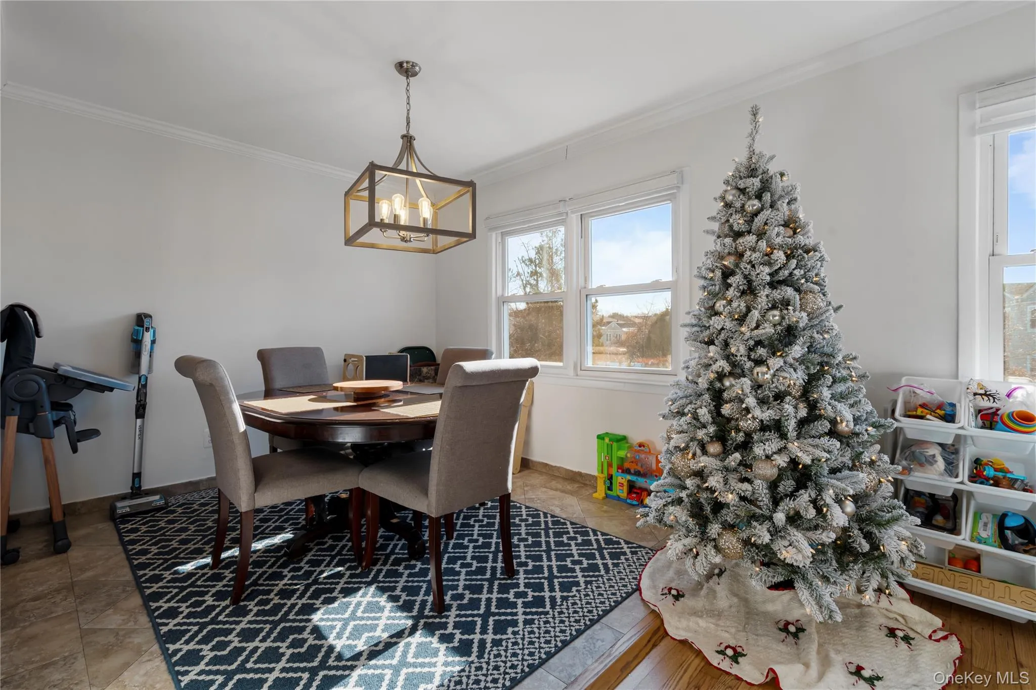 Dining space featuring ornamental molding and a chandelier Dining space featuring ornamental molding and a chandelier