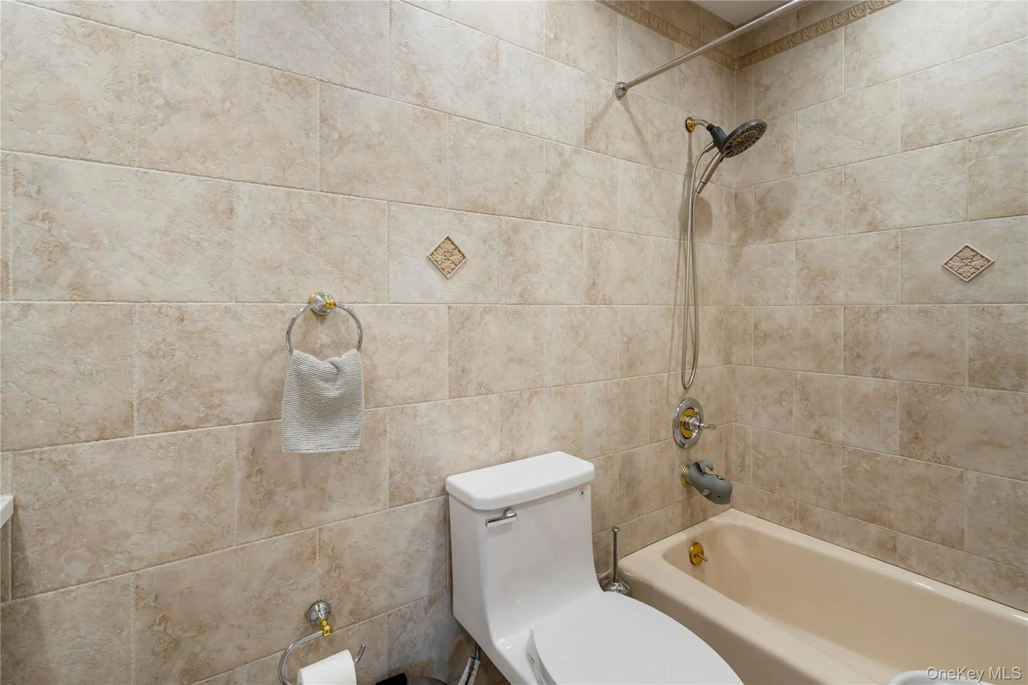 Full bath featuring tub / shower combination and toilet Full bath featuring tub / shower combination and toilet