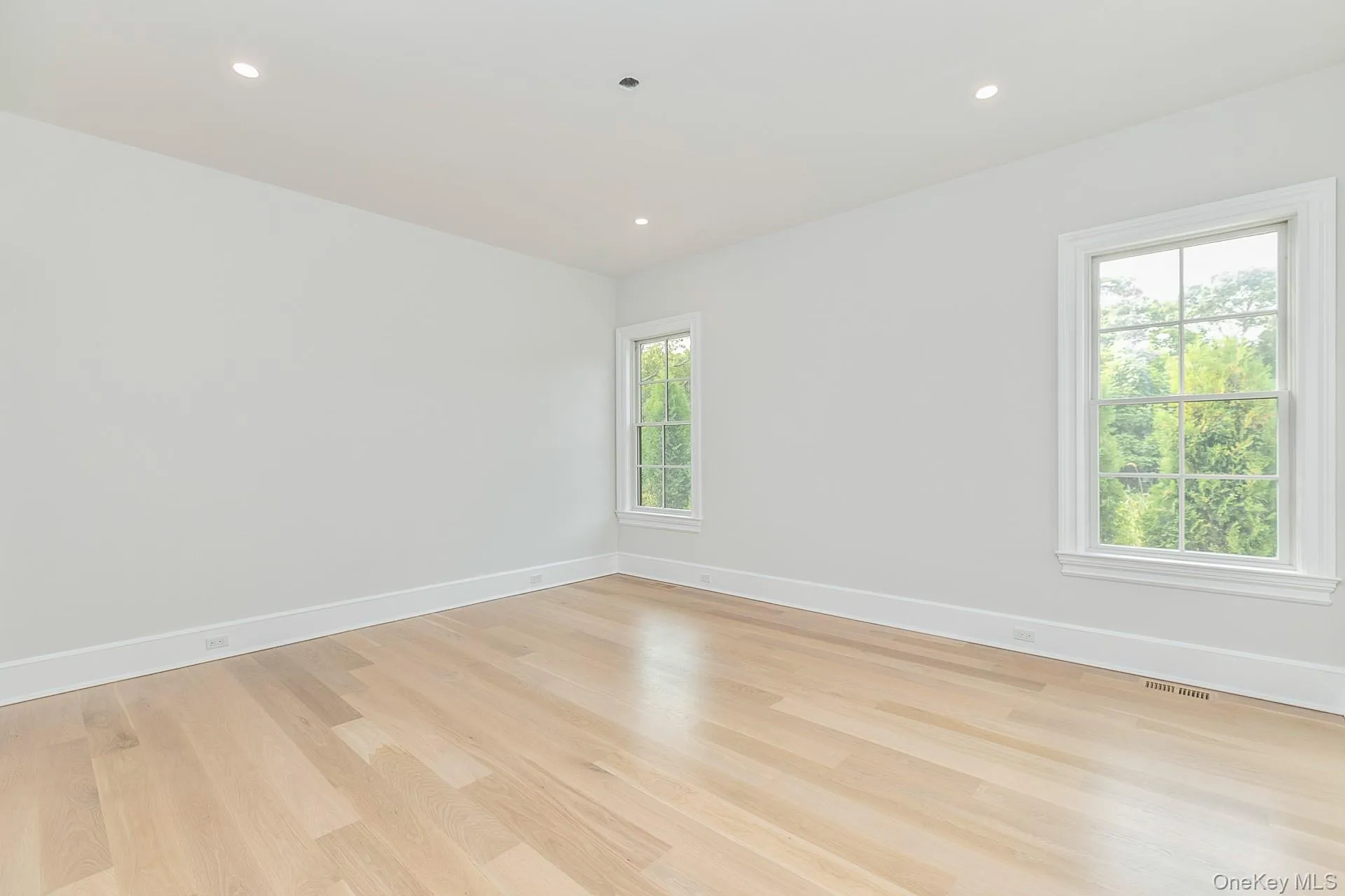 Spare room with light wood-style flooring and recessed lighting Spare room with light wood-style flooring and recessed lighting