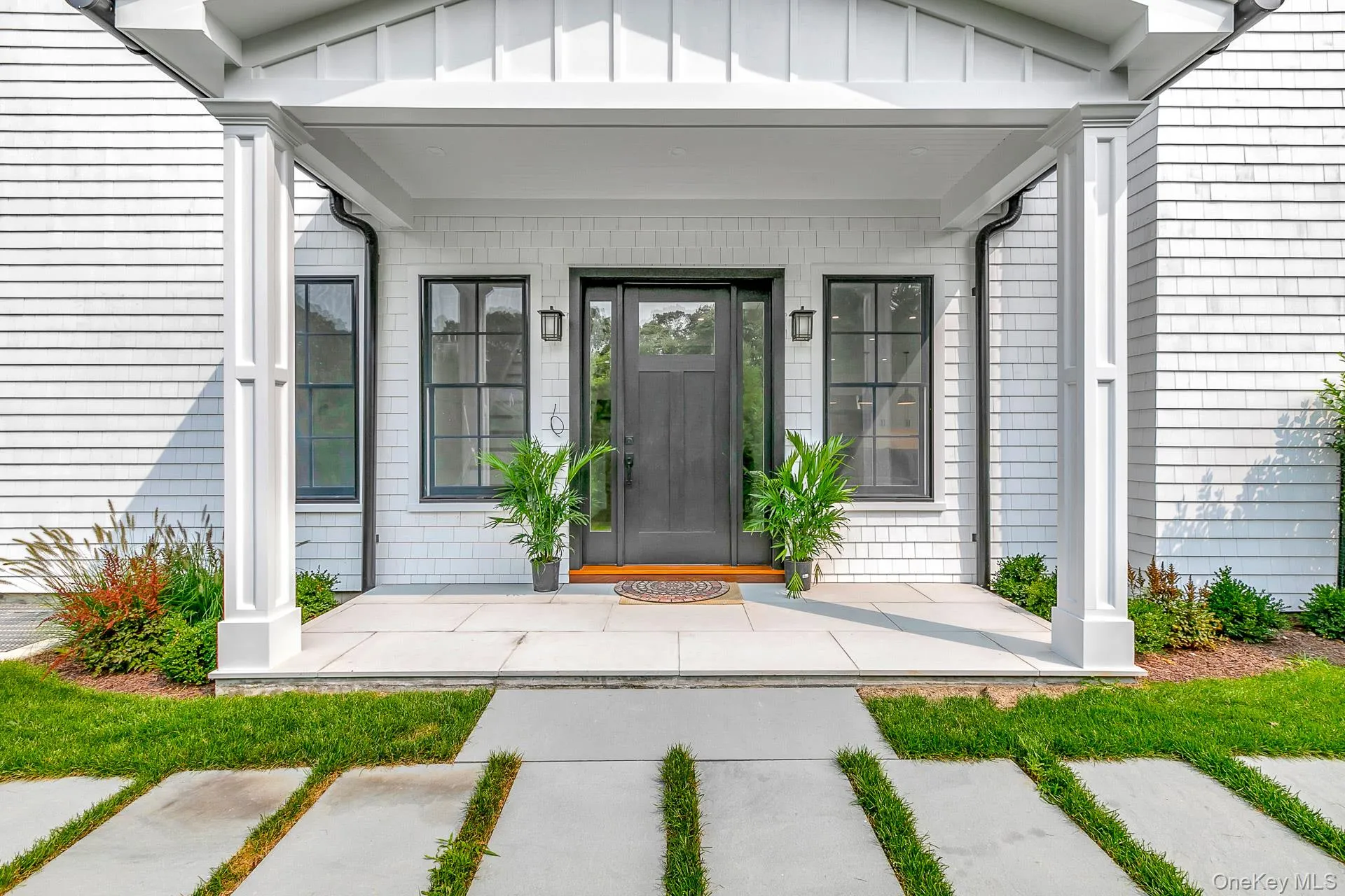 Doorway to property featuring covered porch and board and batten siding Doorway to property featuring covered porch and board and batten siding