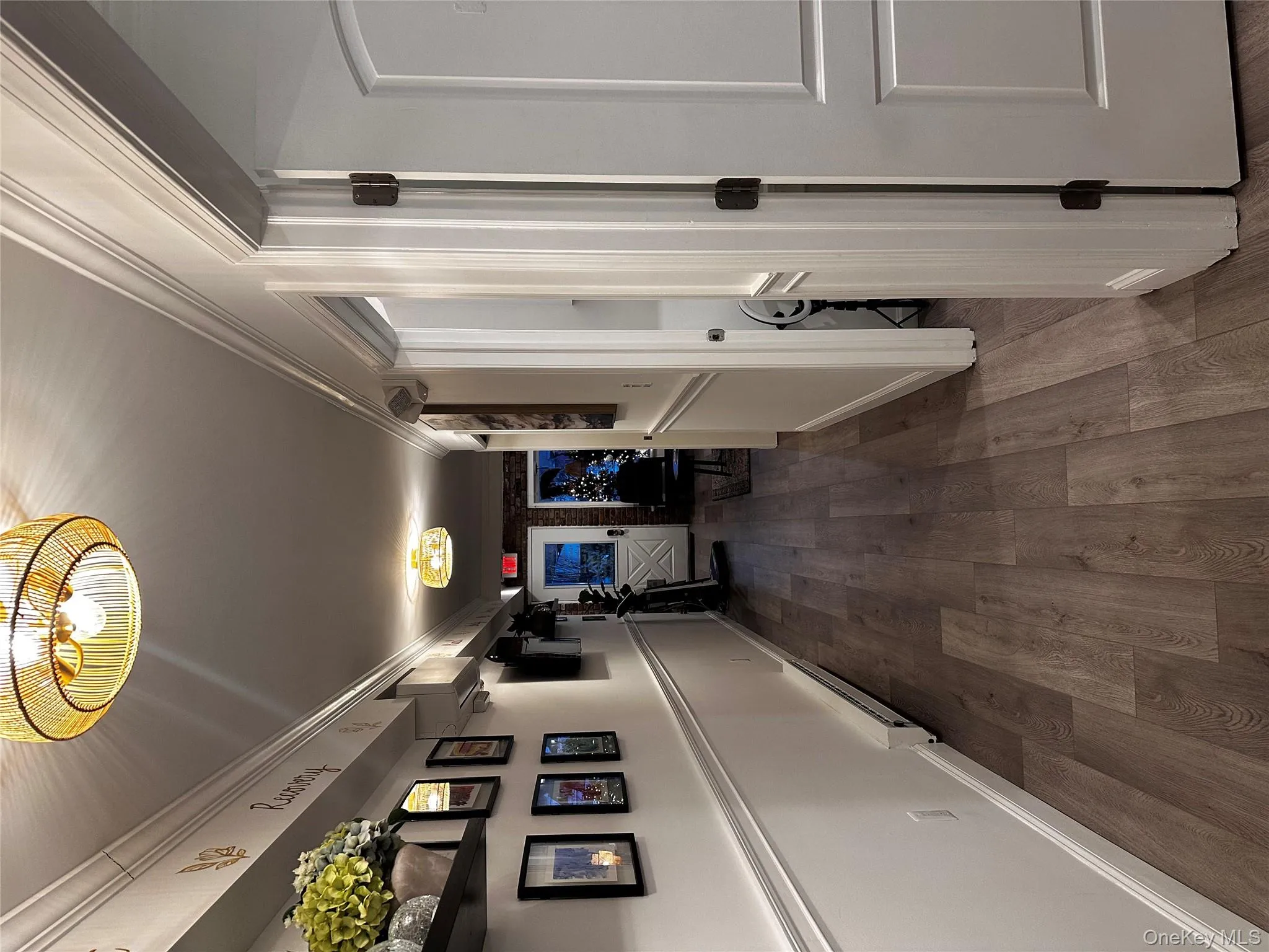 Hall featuring dark wood-style floors, crown molding, and a baseboard radiator Hall featuring dark wood-style floors, crown molding, and a baseboard radiator