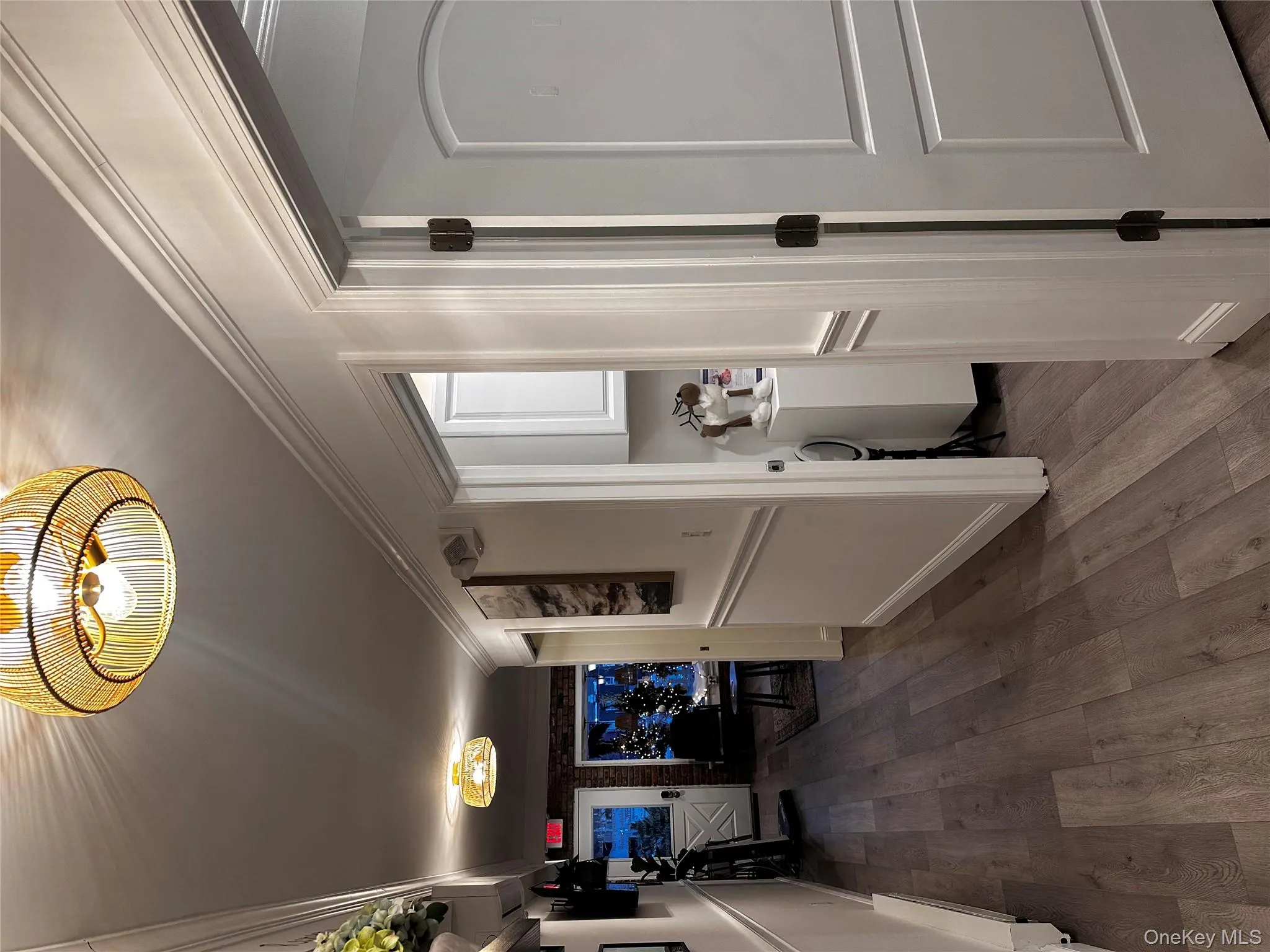 Hallway with dark wood-type flooring and ornamental molding Hallway with dark wood-type flooring and ornamental molding