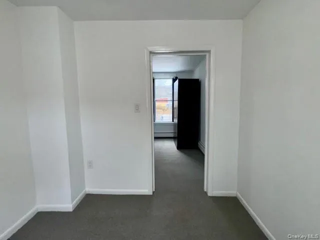 Spare room featuring baseboards and a baseboard heating unit Spare room featuring baseboards and a baseboard heating unit