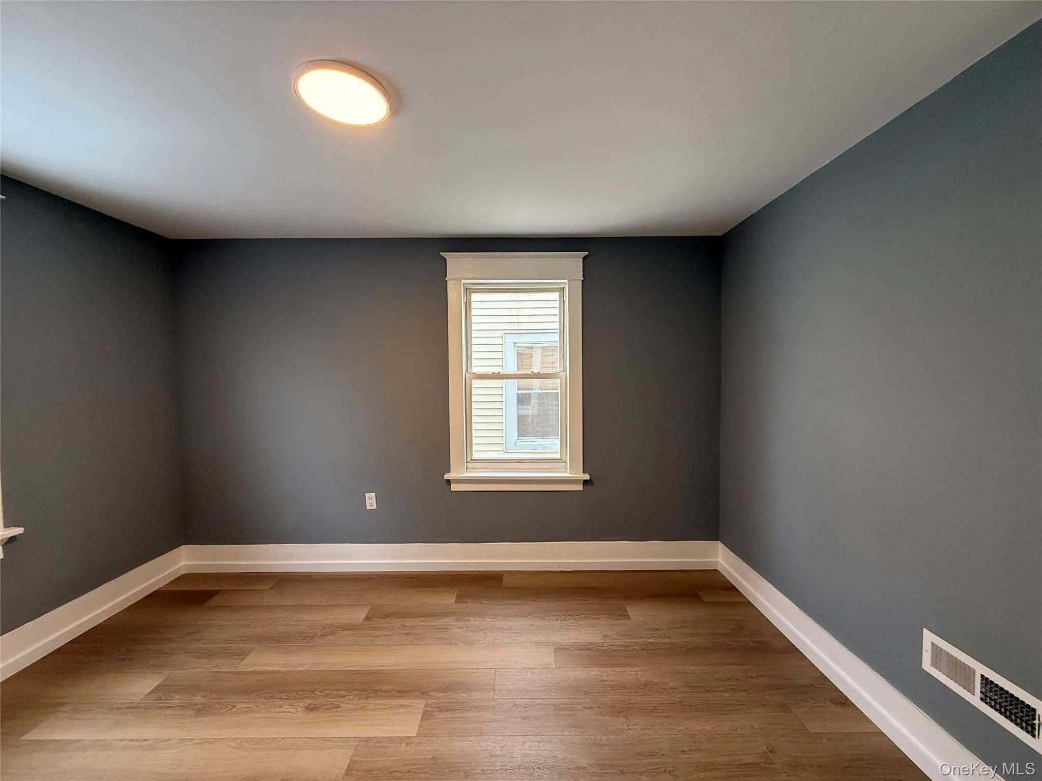 Empty room featuring light wood-style flooring and baseboards Empty room featuring light wood-style flooring and baseboards