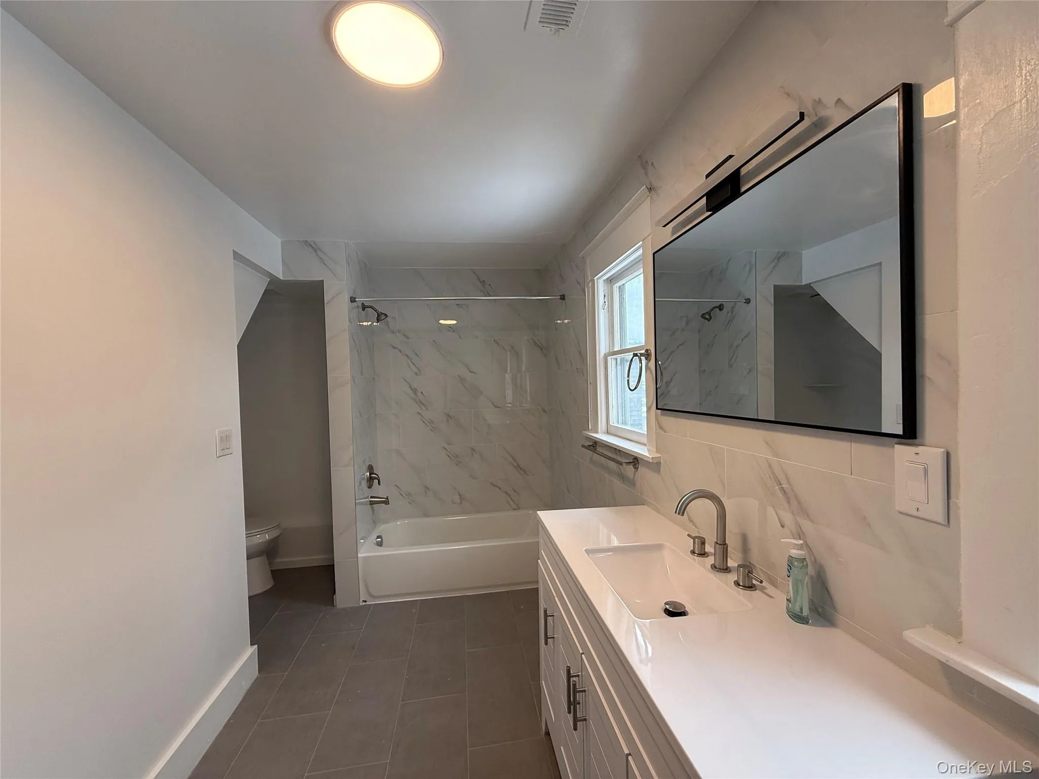 Full bath featuring vanity and shower / bath combination Full bath featuring vanity and shower / bath combination