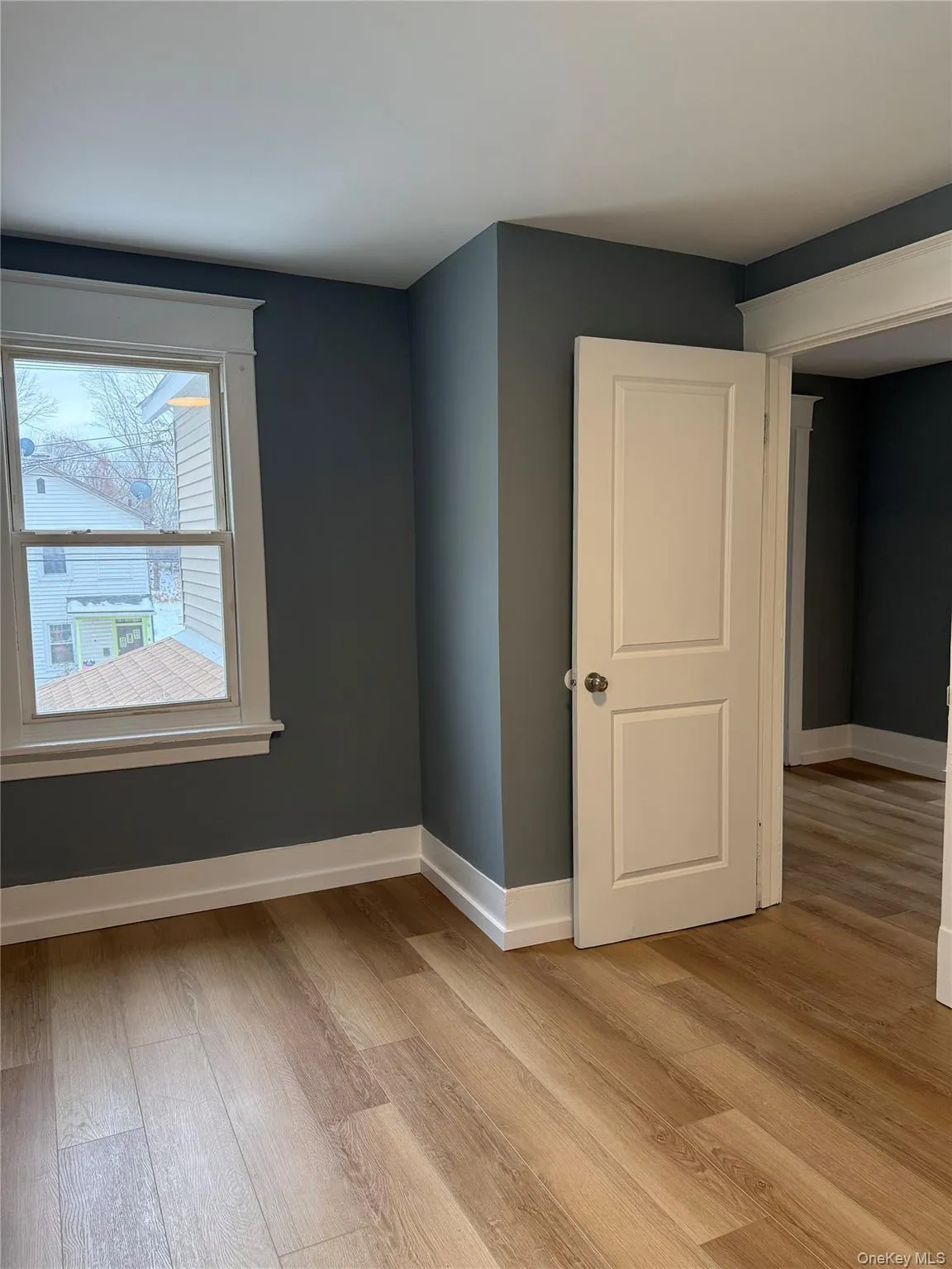 Spare room featuring baseboards and light wood-style floors Spare room featuring baseboards and light wood-style floors