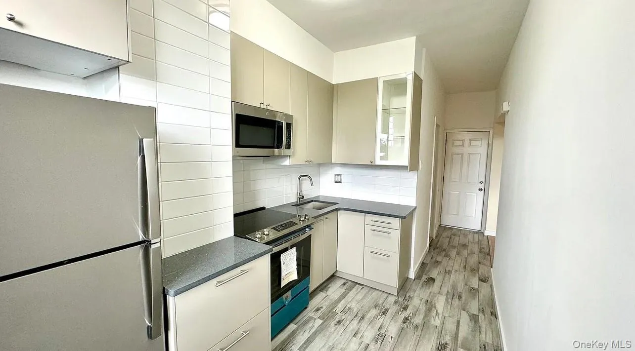 Kitchen with stainless steel appliances, decorative backsplash Kitchen with stainless steel appliances, decorative backsplash