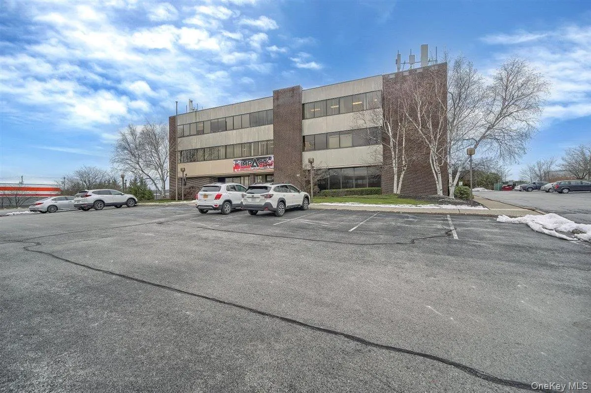 View of commercial property with uncovered parking View of commercial property with uncovered parking