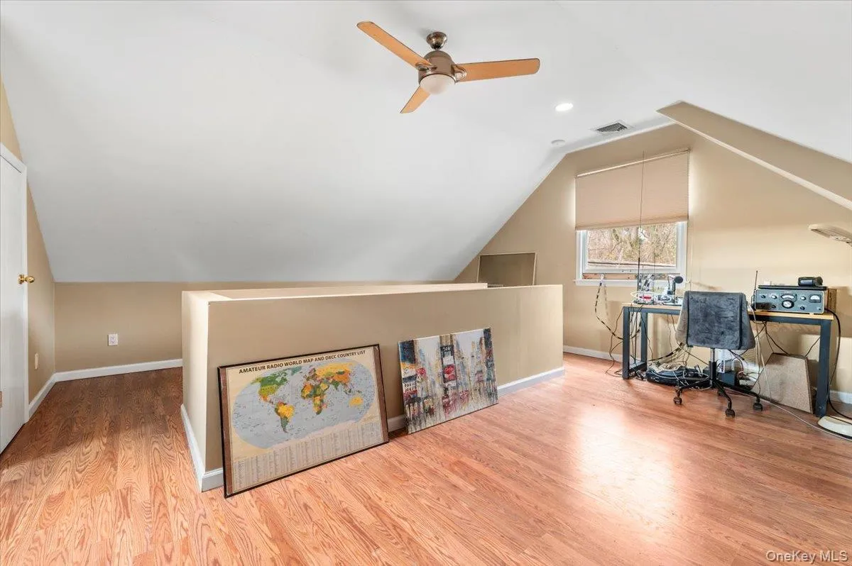Home office featuring wood finished floors, lofted ceiling, a ceiling fan, and recessed lighting Home office featuring wood finished floors, lofted ceiling, a ceiling fan, and recessed lighting