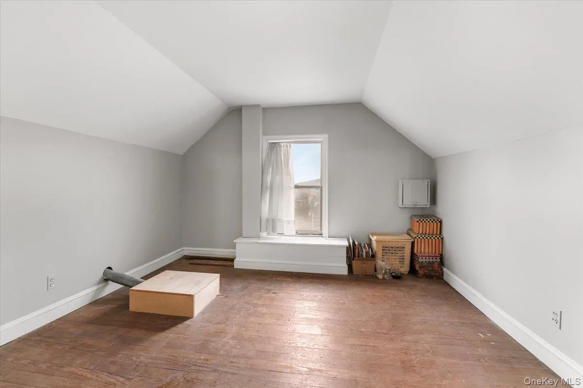 Bonus room featuring vaulted ceiling and hardwood / wood-style flooring Bonus room featuring vaulted ceiling and hardwood / wood-style flooring