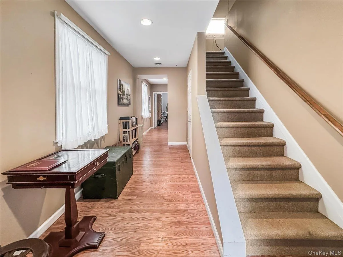 Stairs featuring wood finished floors and recessed lighting Stairs featuring wood finished floors and recessed lighting