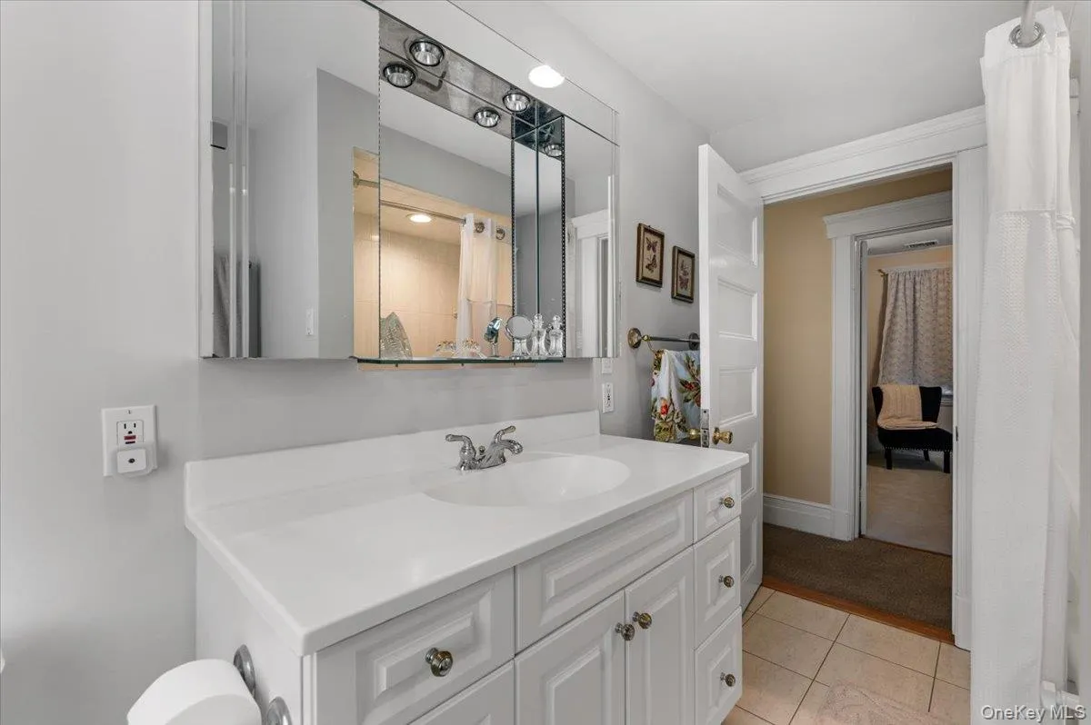 Bathroom with vanity and light tile patterned flooring Bathroom with vanity and light tile patterned flooring