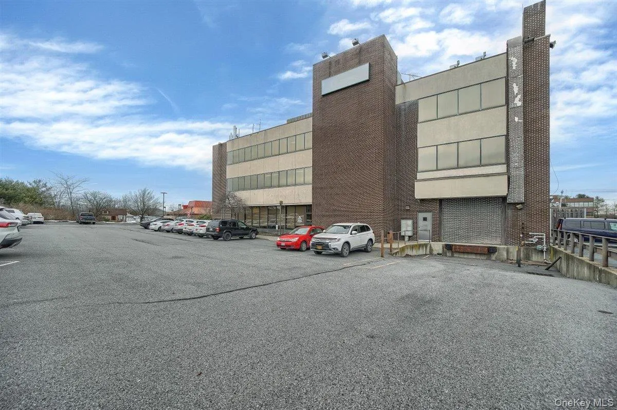 View of building exterior with uncovered parking View of building exterior with uncovered parking