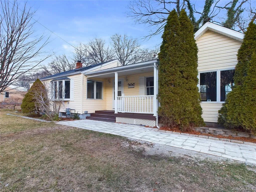 View of front of property with a chimney, covered porch, and a front lawn View of front of property with a chimney, covered porch, and a front lawn