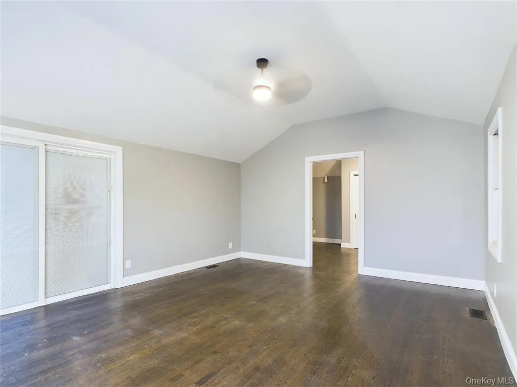 Bonus room featuring lofted ceiling and dark wood finished floors Bonus room featuring lofted ceiling and dark wood finished floors