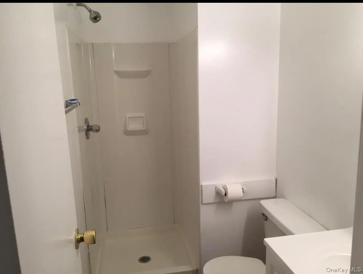 Full bathroom with a stall shower and vanity Full bathroom with a stall shower and vanity