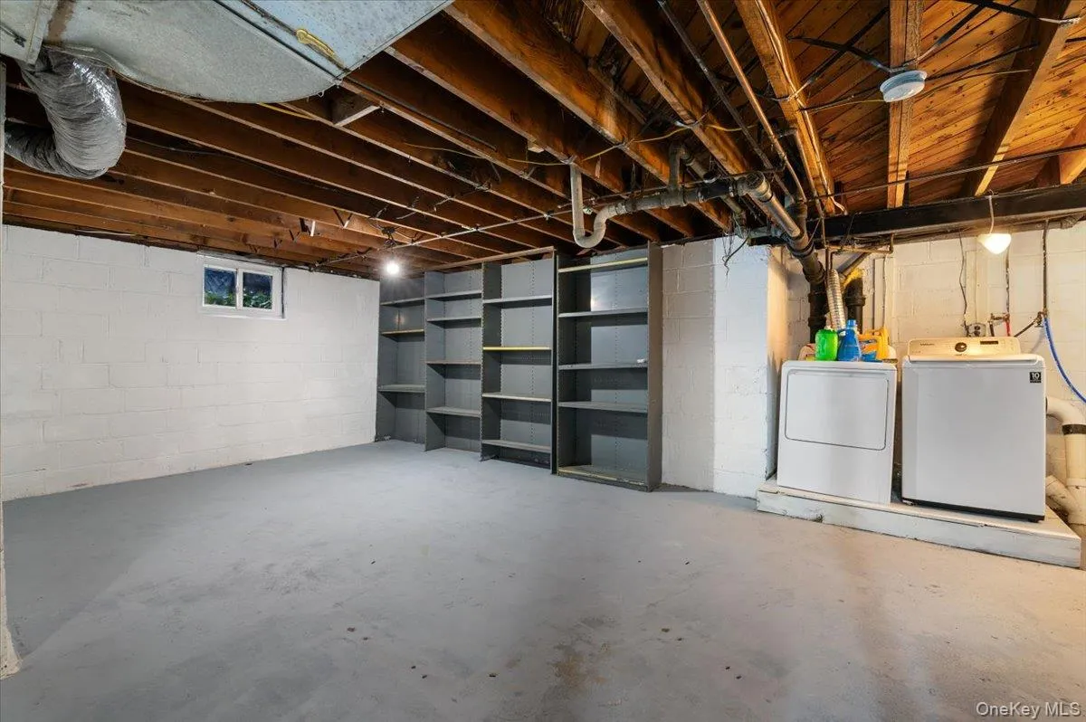 Unfinished below grade area with separate washer and dryer Unfinished below grade area with separate washer and dryer