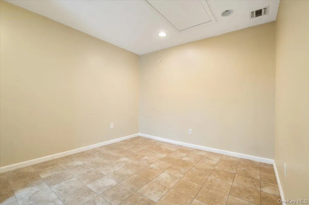 Unfurnished room with attic access and recessed lighting Unfurnished room with attic access and recessed lighting