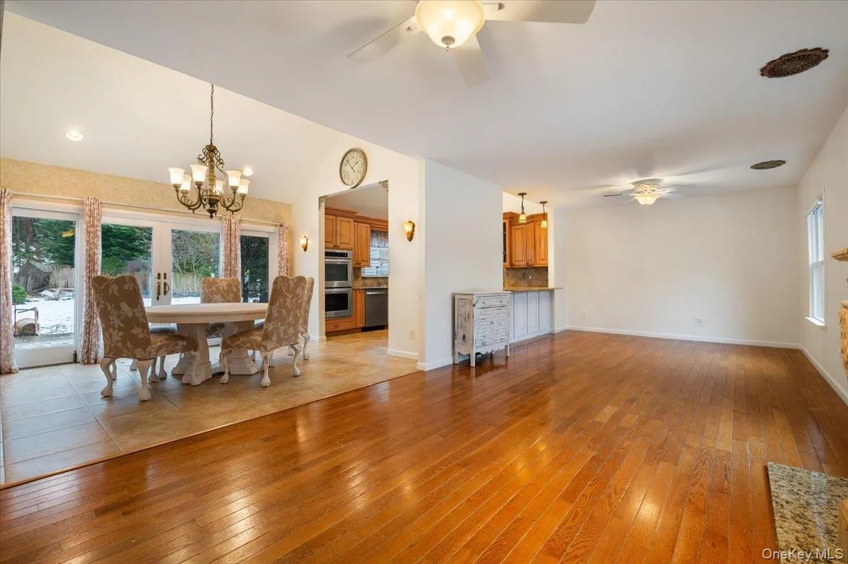 Dining room with plenty of natural light, light wood-style floors, a ceiling fan, and vaulted ceiling Dining room with plenty of natural light, light wood-style floors, a ceiling fan, and vaulted ceiling