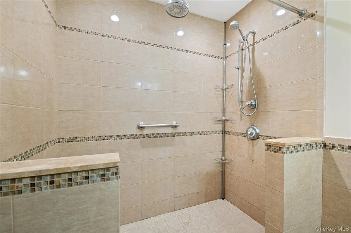 Bathroom featuring tiled shower Bathroom featuring tiled shower