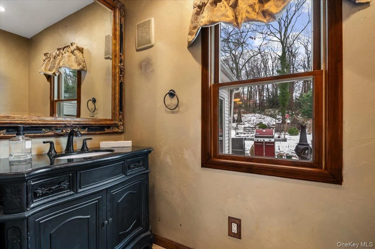 Half Bathroom with a textured wall and vanity Half Bathroom with a textured wall and vanity