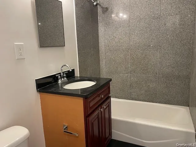Bathroom featuring vanity and shower / tub combination Bathroom featuring vanity and shower / tub combination