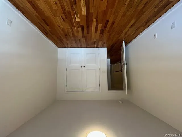 Bedroom 2 featuring dark wood-style floors and a closet Bedroom 2 featuring dark wood-style floors and a closet