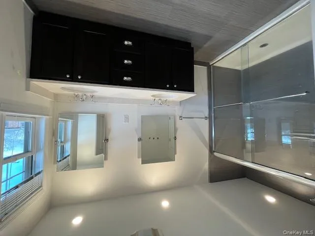 Full bathroom featuring double vanity and a shower stall Full bathroom featuring double vanity and a shower stall