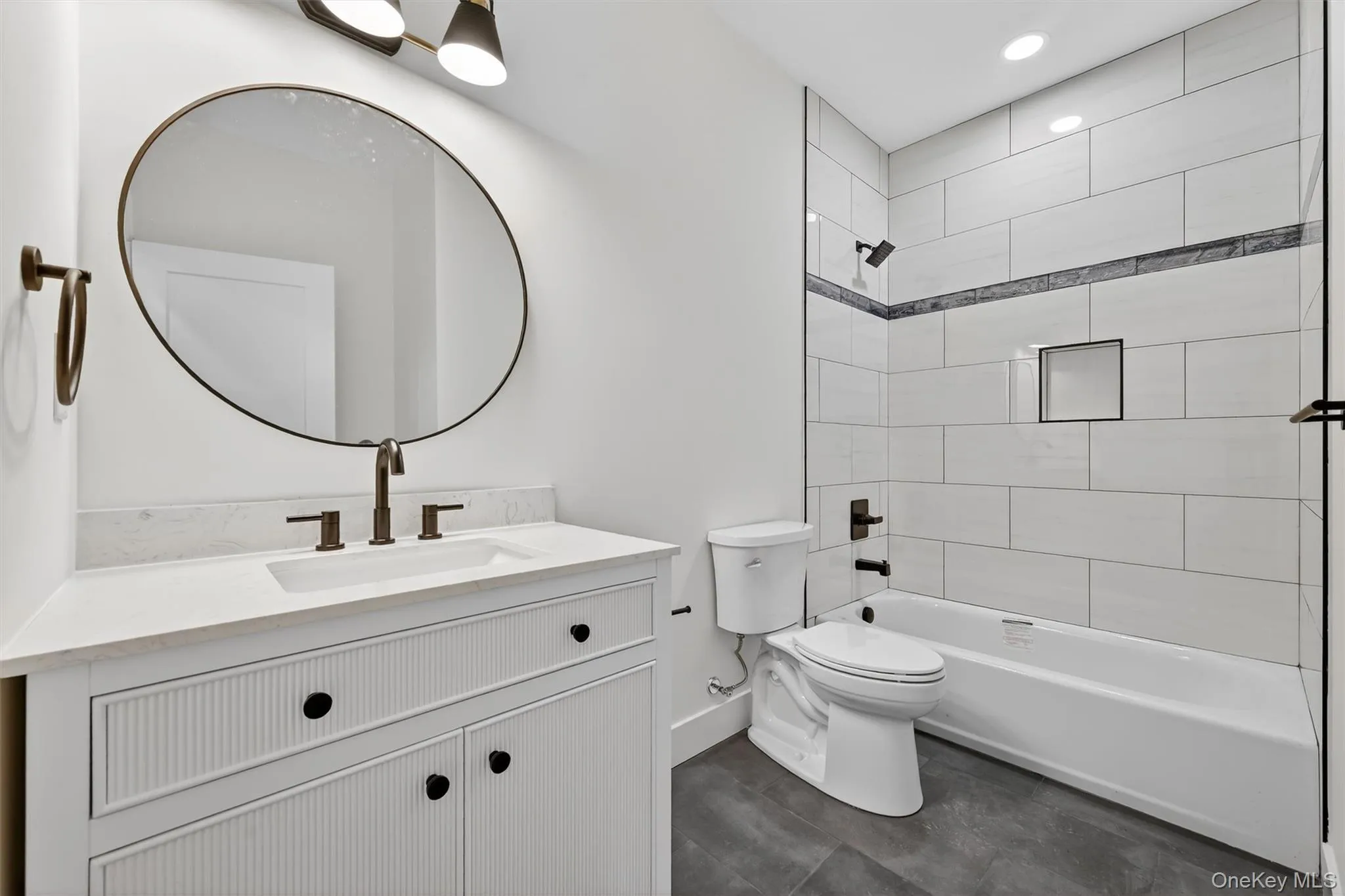 Bathroom with vanity, shower / tub combination, and recessed lighting Bathroom with vanity, shower / tub combination, and recessed lighting