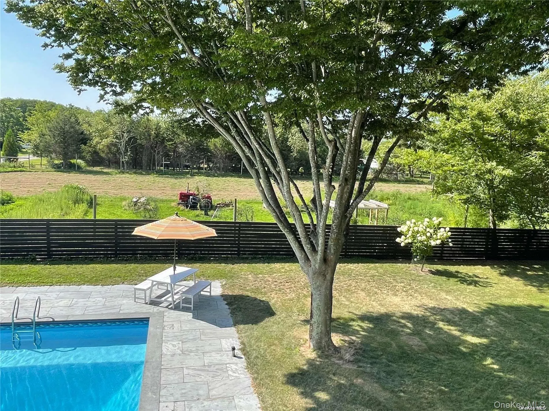 pool side with view of farm pool side with view of farm