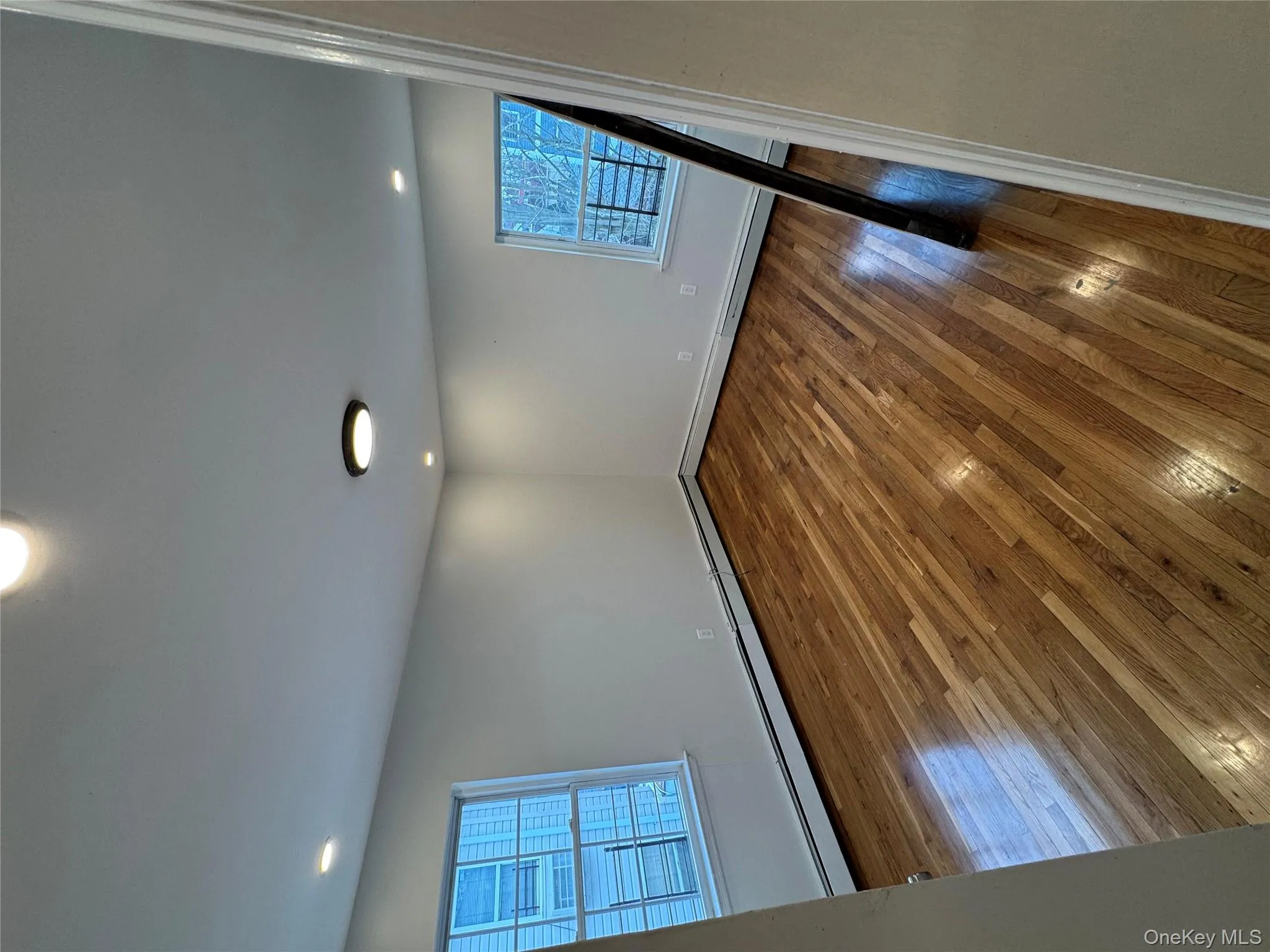 Spare room with healthy amount of natural light, dark wood-style flooring, a baseboard heating unit, and recessed lighting Spare room with healthy amount of natural light, dark wood-style flooring, a baseboard heating unit, and recessed lighting