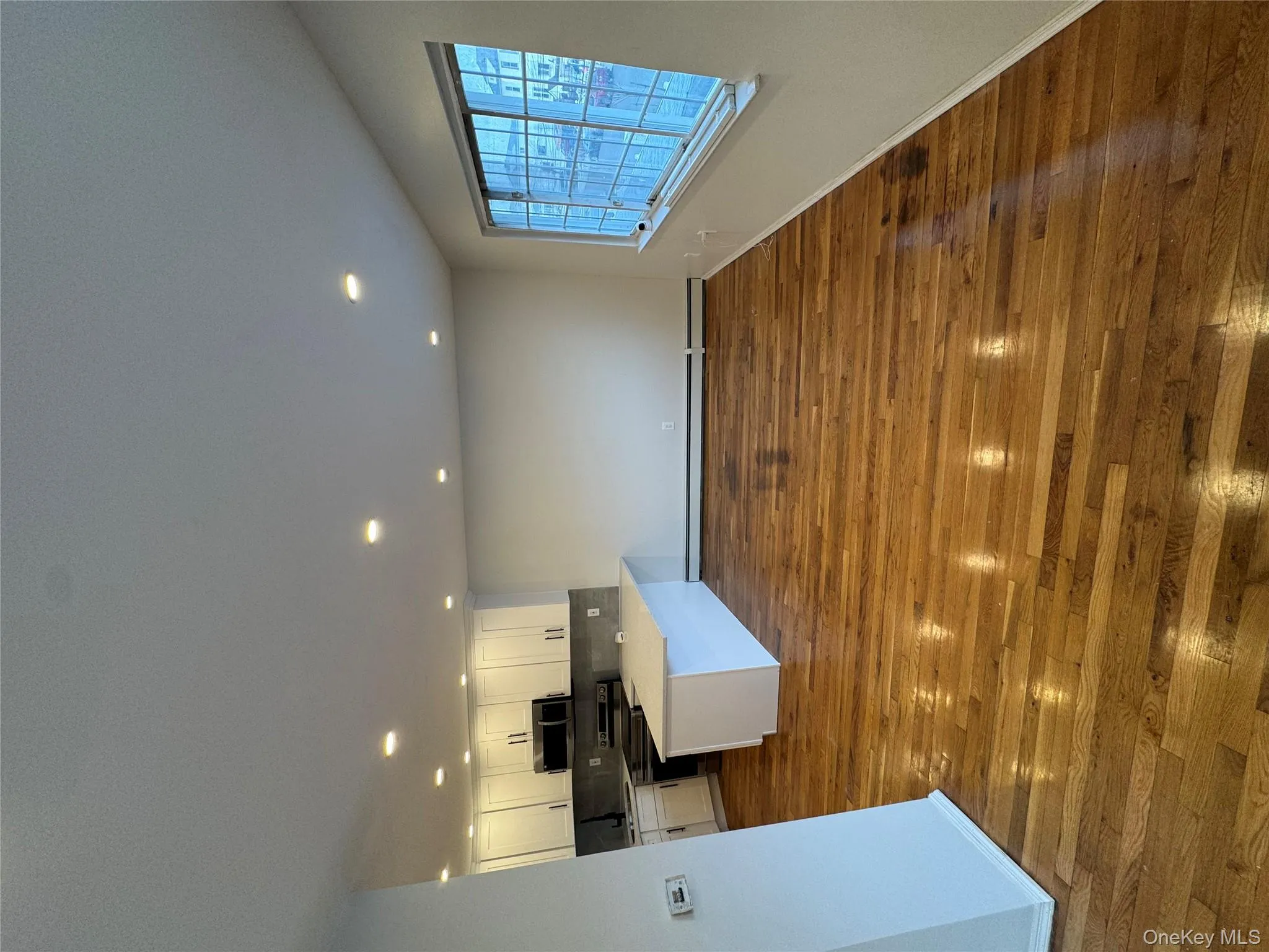 Kitchen with white cabinetry, a peninsula, stove, recessed lighting, and open floor plan Kitchen with white cabinetry, a peninsula, stove, recessed lighting, and open floor plan