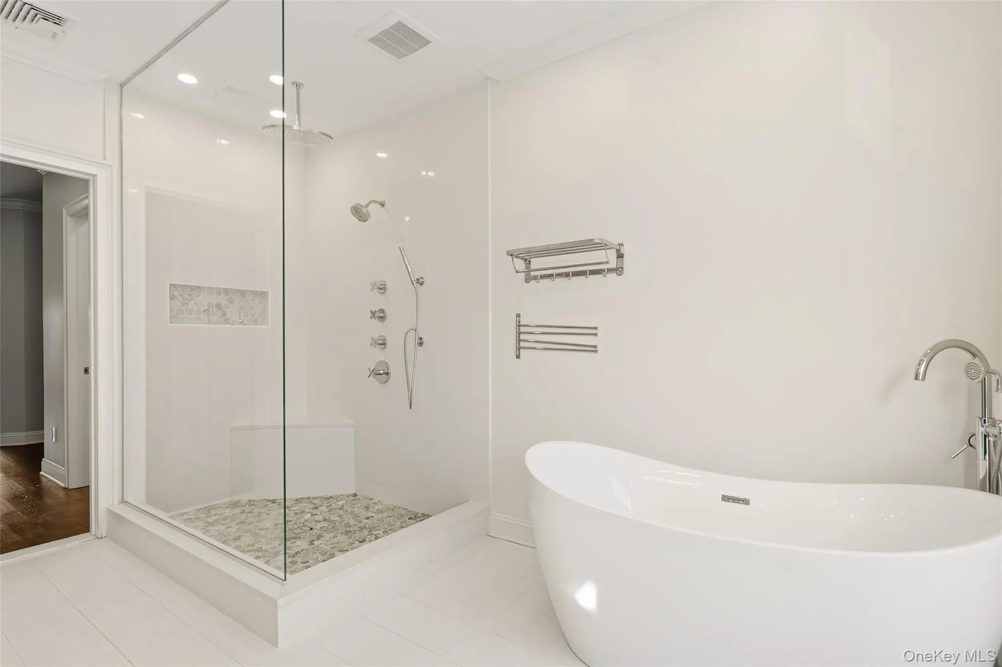 Full bath featuring a soaking tub, a stall shower, recessed lighting, tile patterned floors, and crown molding Full bath featuring a soaking tub, a stall shower, recessed lighting, tile patterned floors, and crown molding