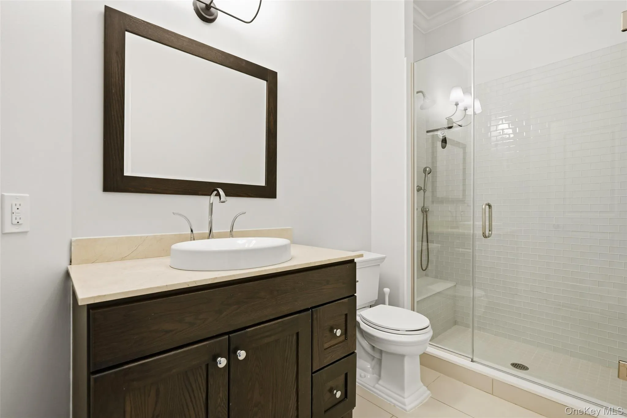 Bathroom with vanity, a stall shower, and light tile patterned flooring Bathroom with vanity, a stall shower, and light tile patterned flooring