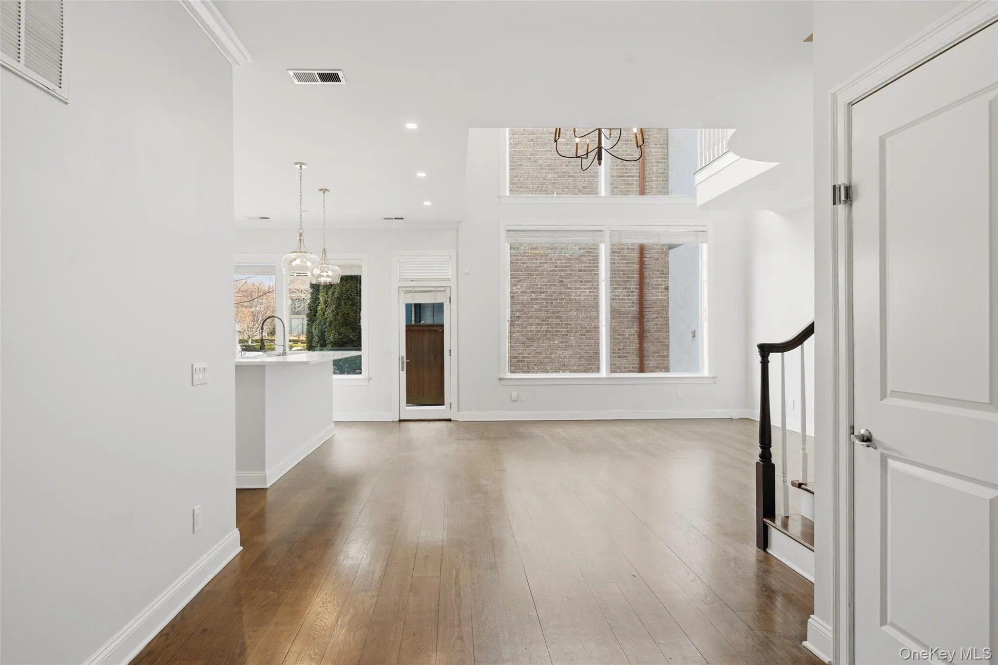 Entryway with a chandelier, dark wood-style floors, recessed lighting, and stairs Entryway with a chandelier, dark wood-style floors, recessed lighting, and stairs