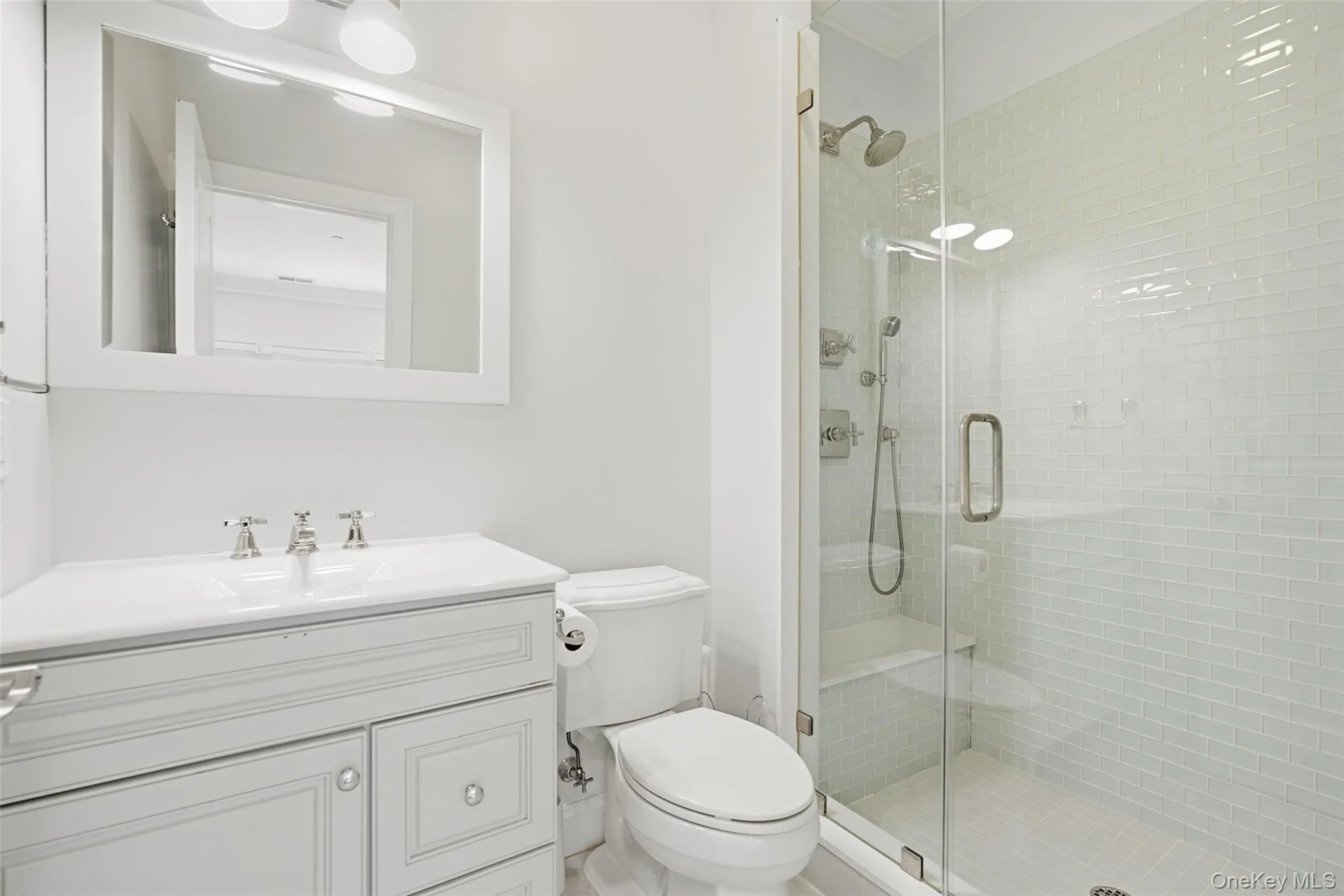 Full bath featuring vanity and a shower stall Full bath featuring vanity and a shower stall