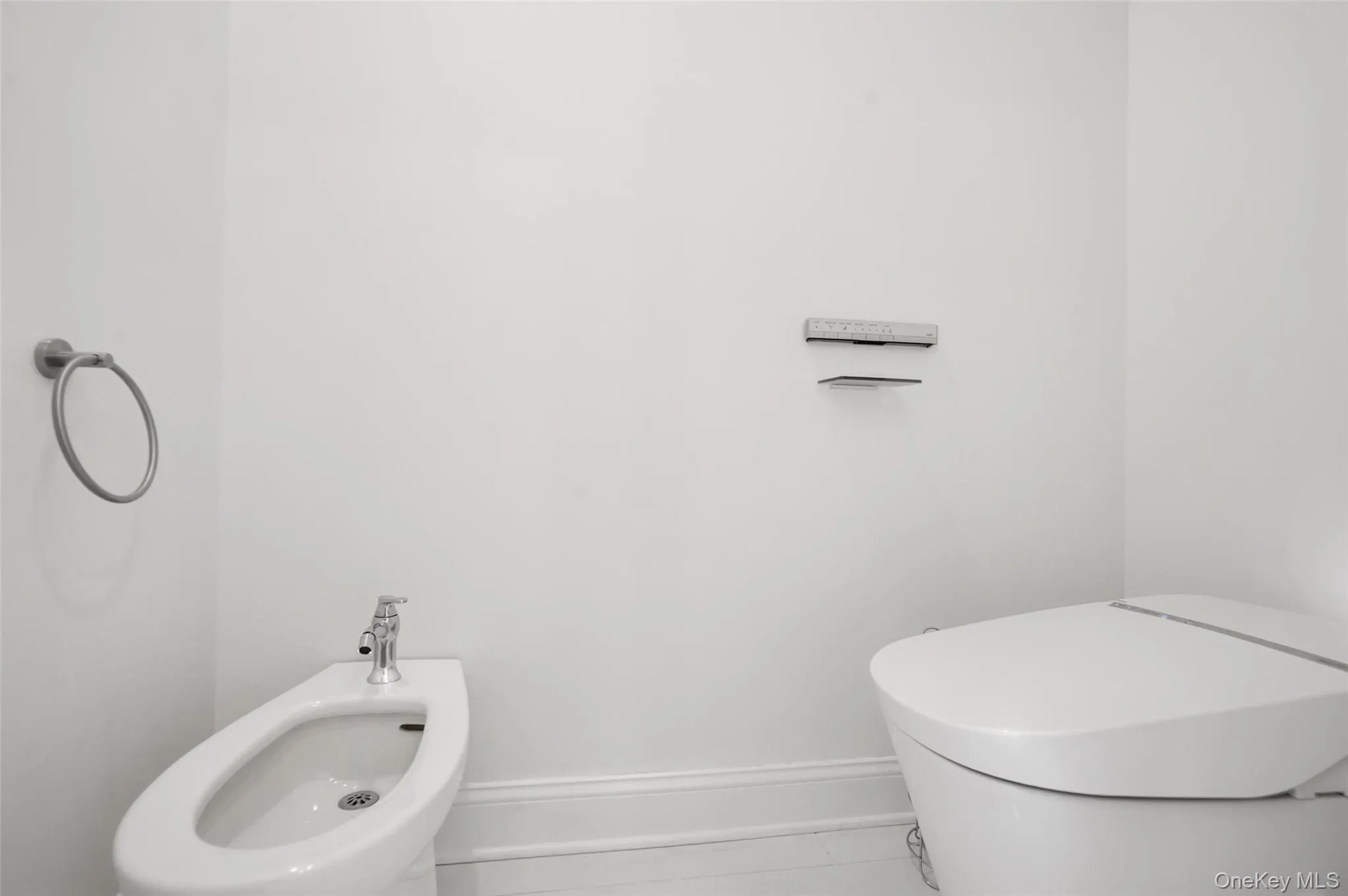 Half bath featuring a bidet and toilet Half bath featuring a bidet and toilet