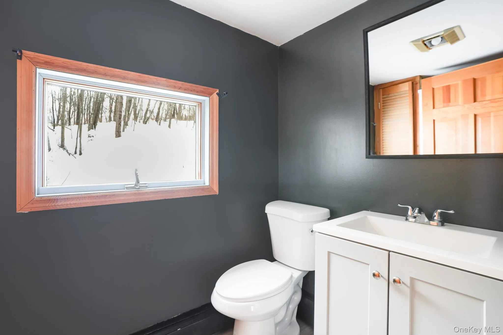 Bathroom featuring vanity and toilet Bathroom featuring vanity and toilet