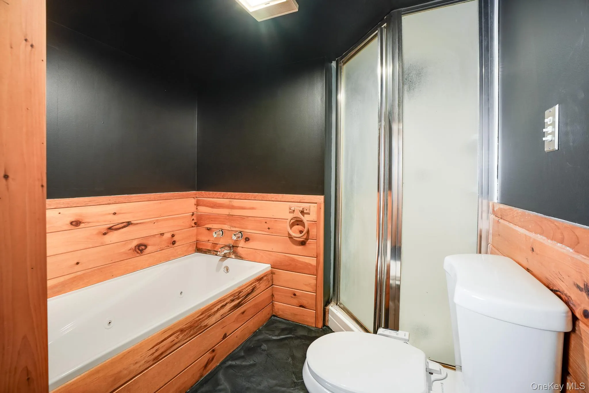 Full bath with a garden tub and a shower stall Full bath with a garden tub and a shower stall