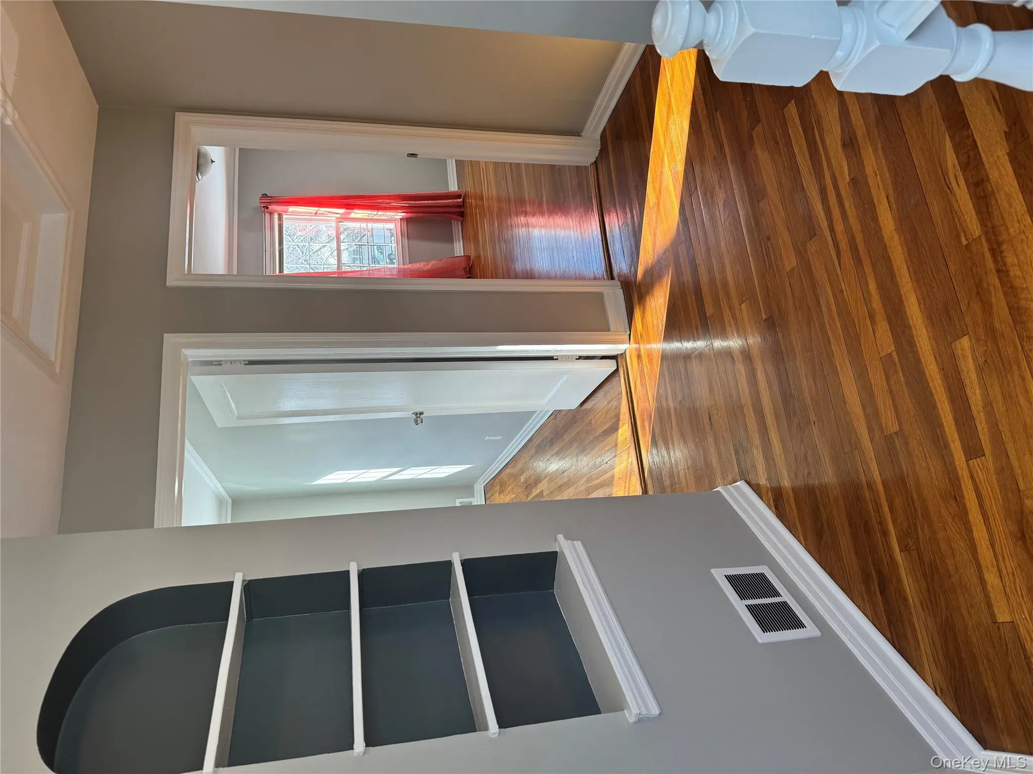 Spare room featuring dark wood-style floors and crown molding Spare room featuring dark wood-style floors and crown molding