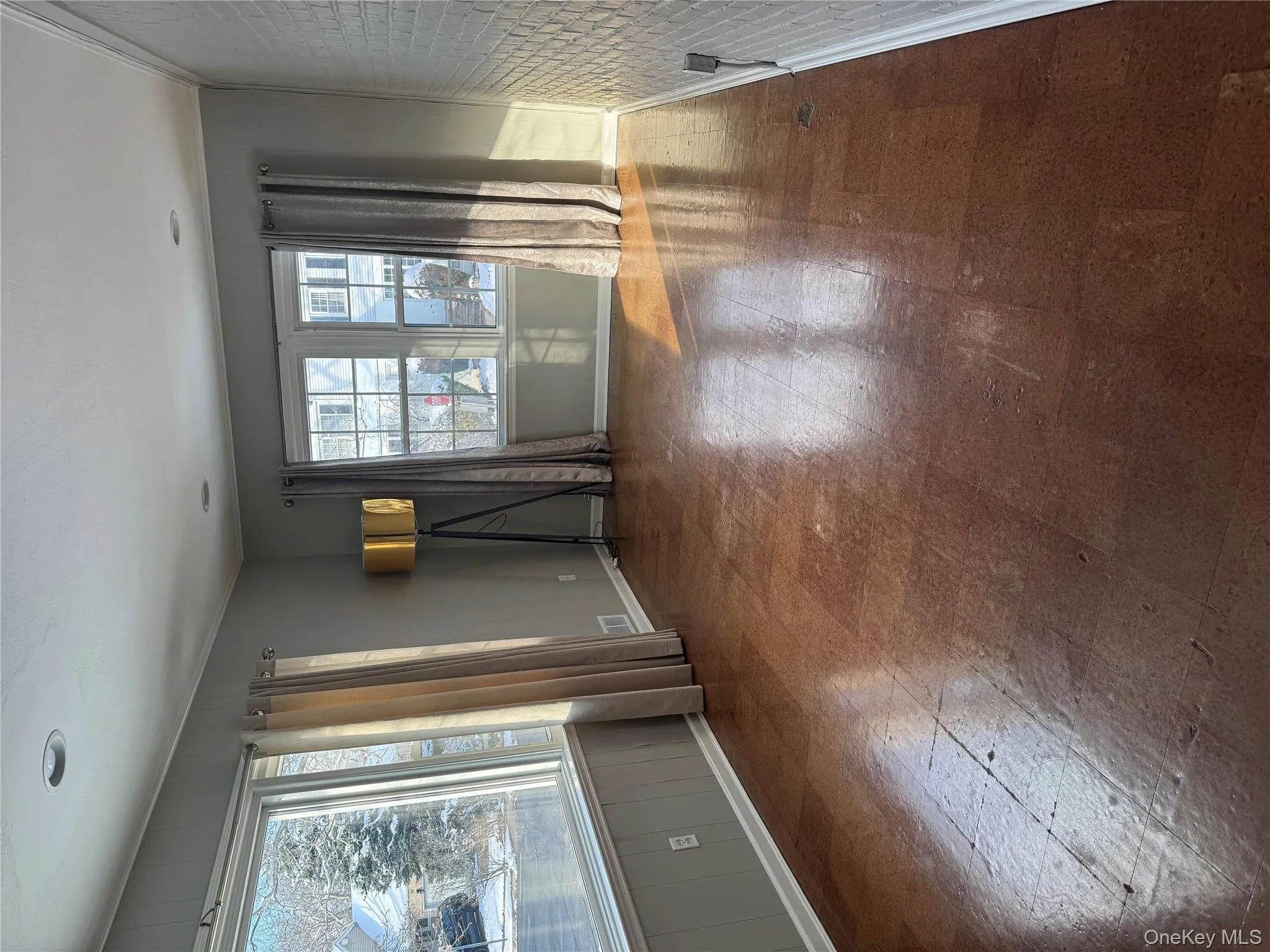 Spare room with baseboards and tile patterned floors Spare room with baseboards and tile patterned floors