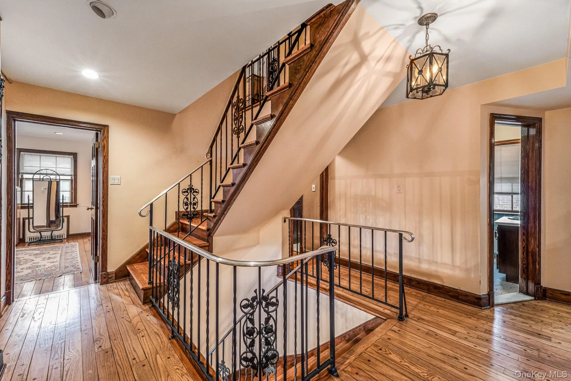 Stairs with wood-type flooring and a chandelier Stairs with wood-type flooring and a chandelier