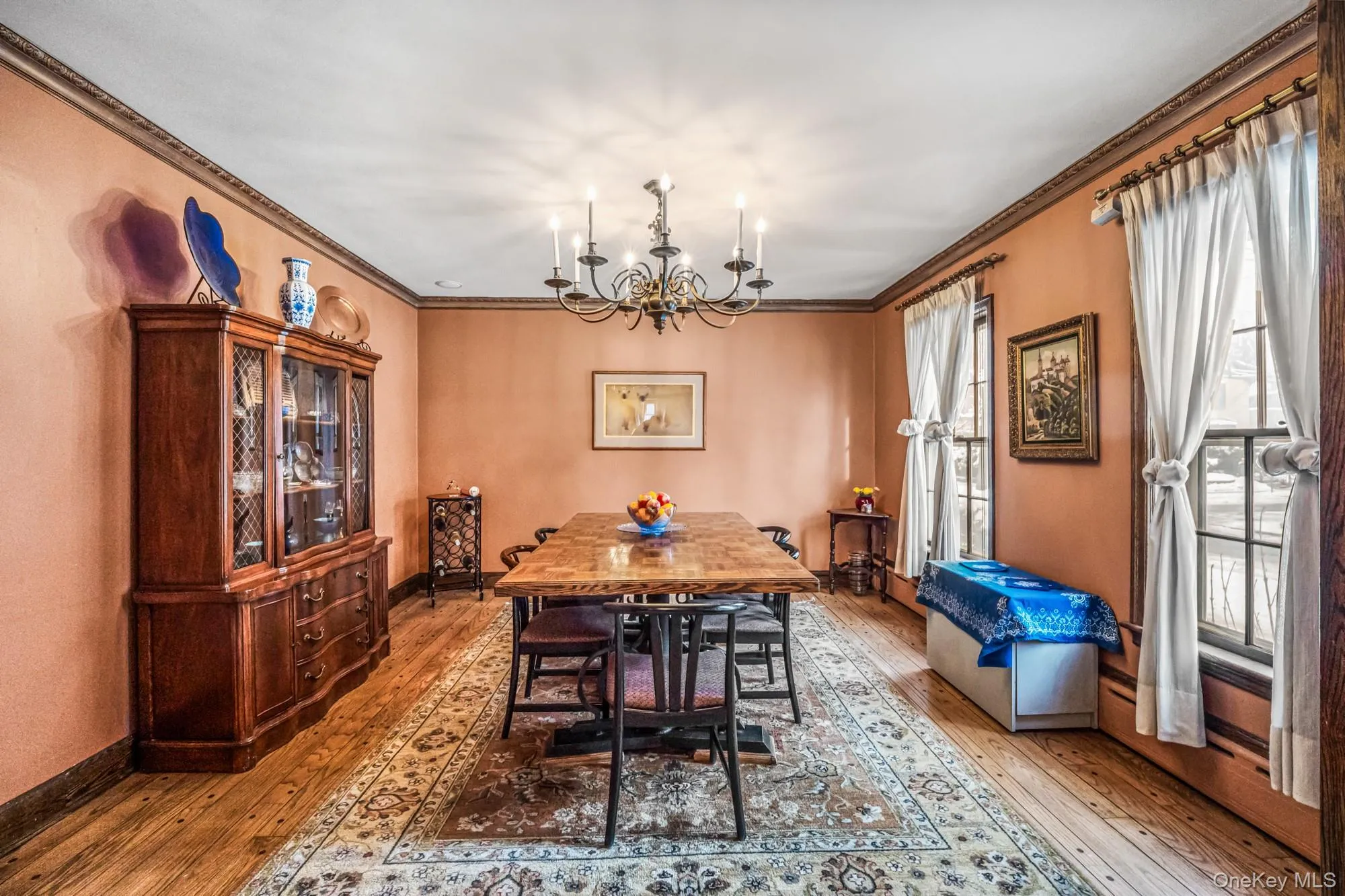 Dining area with hardwood / wood-style floors, a chandelier, and ornamental molding Dining area with hardwood / wood-style floors, a chandelier, and ornamental molding