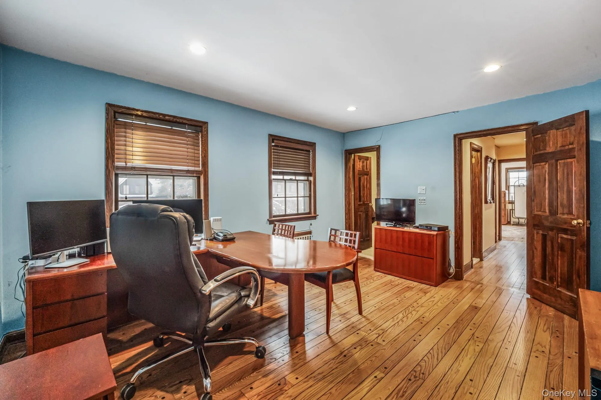 Office space with light wood-style flooring and recessed lighting Office space with light wood-style flooring and recessed lighting