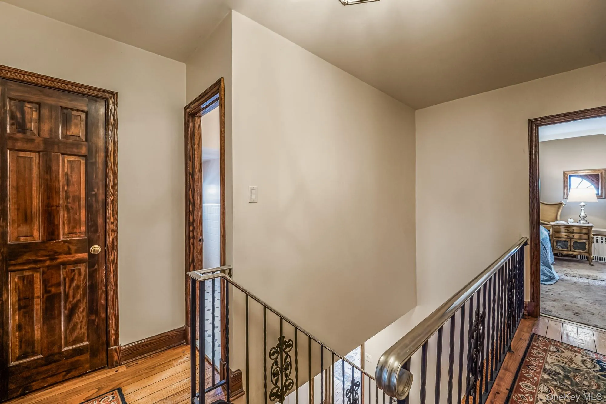 Hall with wood-type flooring and an upstairs landing Hall with wood-type flooring and an upstairs landing